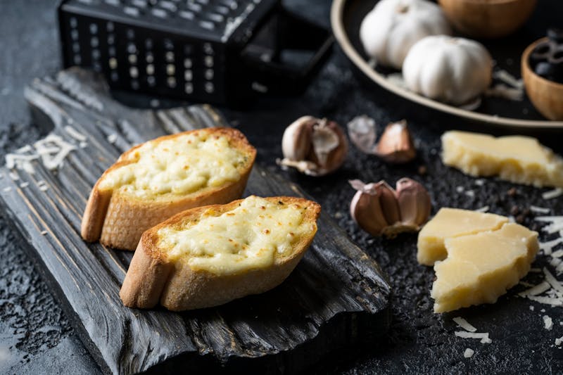 Freshly baked garlic knots with herbs and parmesan